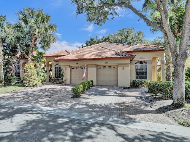 mediterranean / spanish-style home with a garage