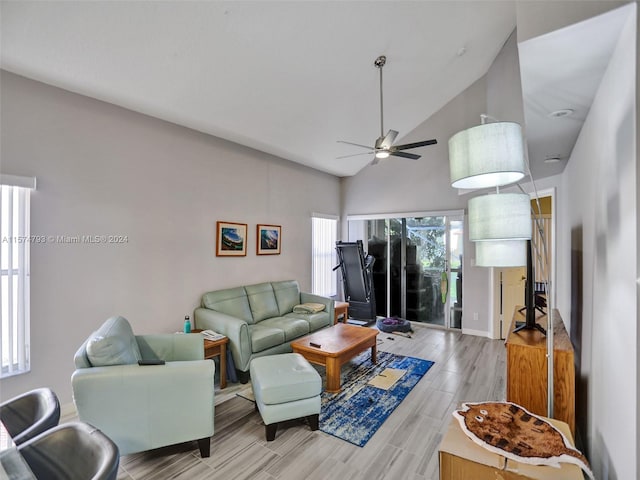 living room featuring high vaulted ceiling, ceiling fan, and wood-type flooring