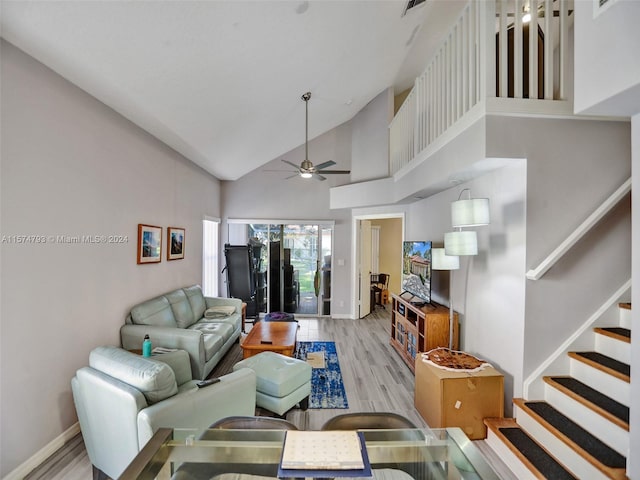 living room with high vaulted ceiling, ceiling fan, and light wood-type flooring