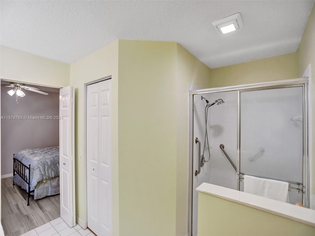 bathroom featuring tile floors, ceiling fan, and an enclosed shower