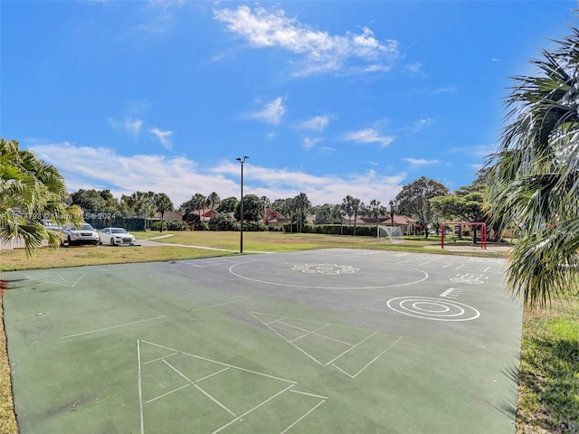 view of basketball court with a playground and a yard