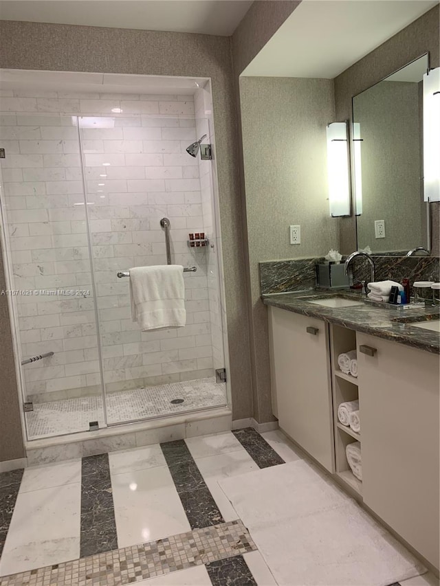 bathroom featuring a shower with shower door, double vanity, and tile flooring