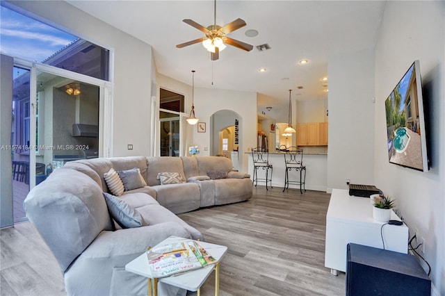 living room featuring ceiling fan and wood-type flooring