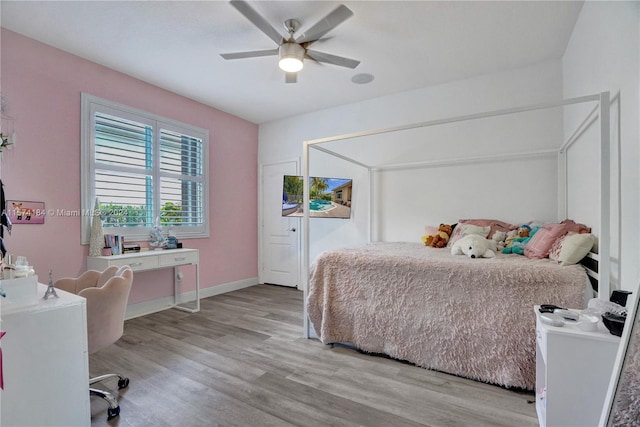 bedroom with light hardwood / wood-style floors and ceiling fan