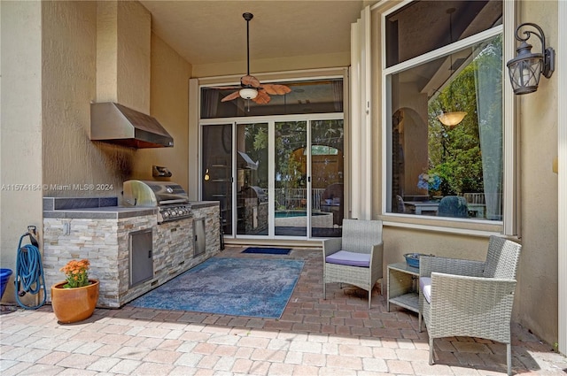 property entrance featuring a patio, ceiling fan, and an outdoor kitchen