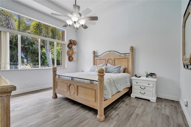 bedroom with ceiling fan and light hardwood / wood-style flooring