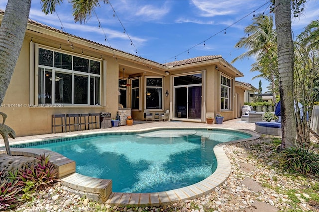 view of swimming pool featuring a patio and ceiling fan