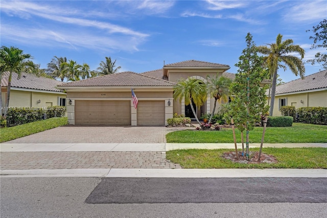 mediterranean / spanish home with a garage and a front yard