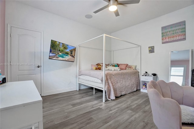 bedroom with ceiling fan and hardwood / wood-style flooring