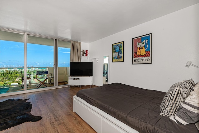 bedroom featuring access to outside and dark wood-type flooring