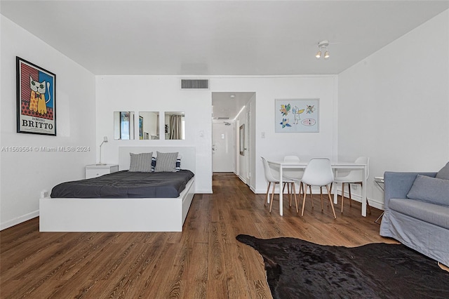 bedroom featuring dark hardwood / wood-style flooring