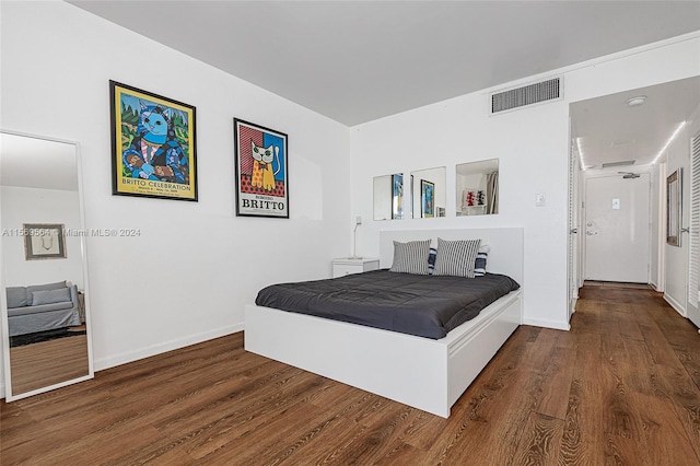 bedroom featuring dark hardwood / wood-style flooring