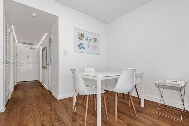 dining space with wood-type flooring