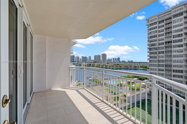 balcony featuring a water view and a view of city