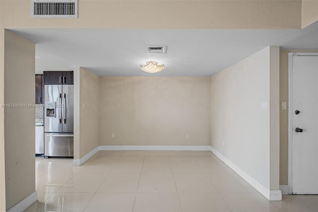 unfurnished room featuring visible vents, baseboards, and light tile patterned floors