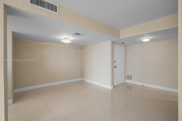 tiled spare room with visible vents and baseboards