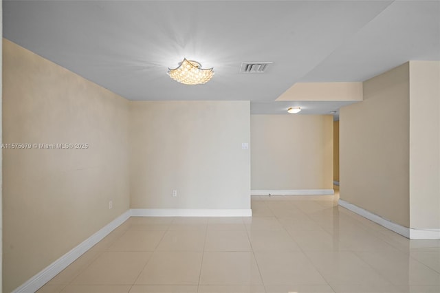 spare room with visible vents, baseboards, and light tile patterned floors