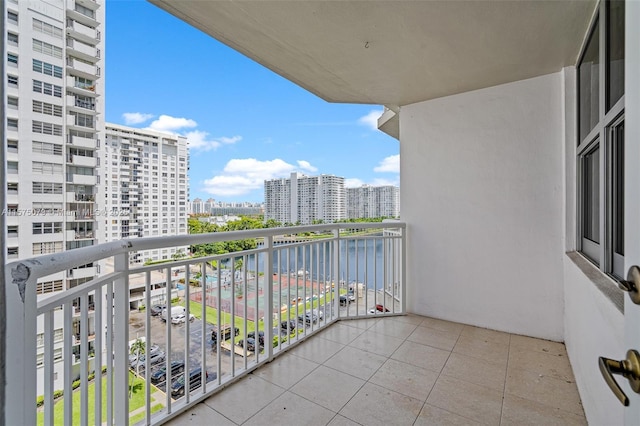 balcony featuring a water view and a view of city