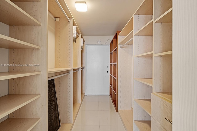 walk in closet featuring tile patterned flooring