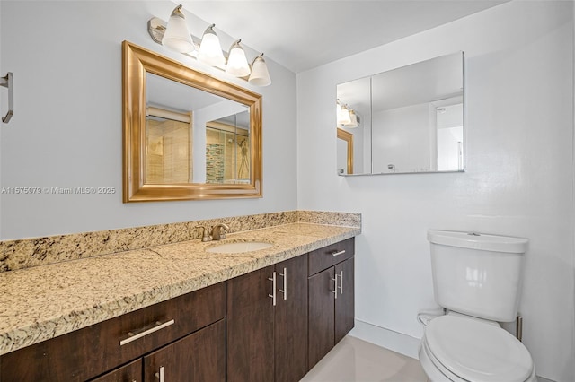 full bath featuring baseboards, vanity, and toilet