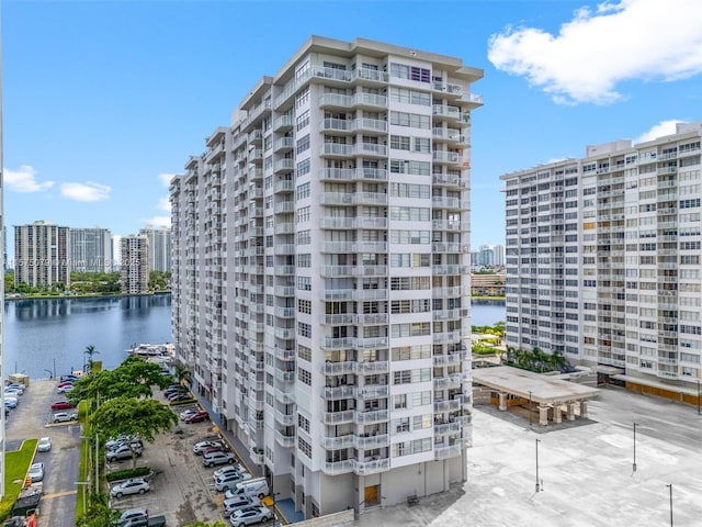 view of building exterior with a water view and a city view