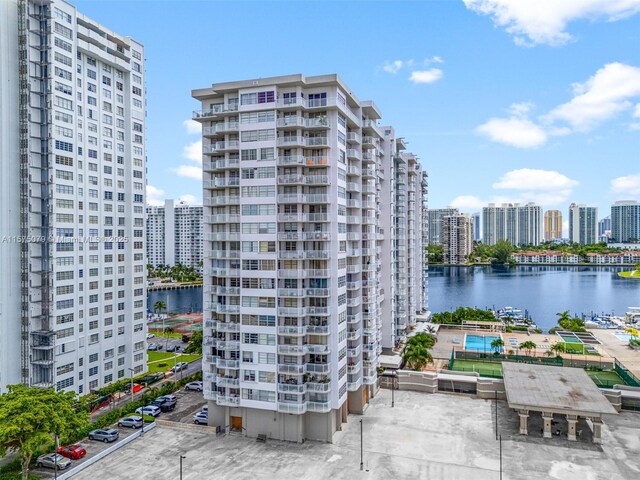 view of property featuring a water view and a city view