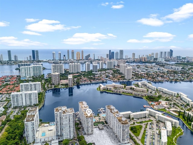 birds eye view of property featuring a water view and a city view