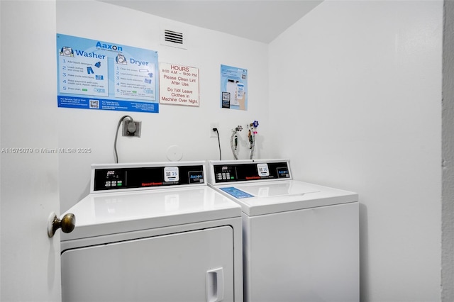 shared laundry area with visible vents and washing machine and clothes dryer