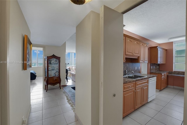 kitchen with sink, plenty of natural light, and light tile floors