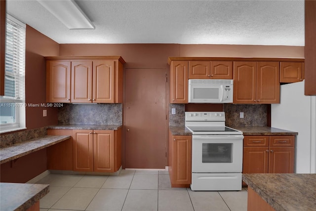 kitchen featuring backsplash, a textured ceiling, white appliances, and light tile floors