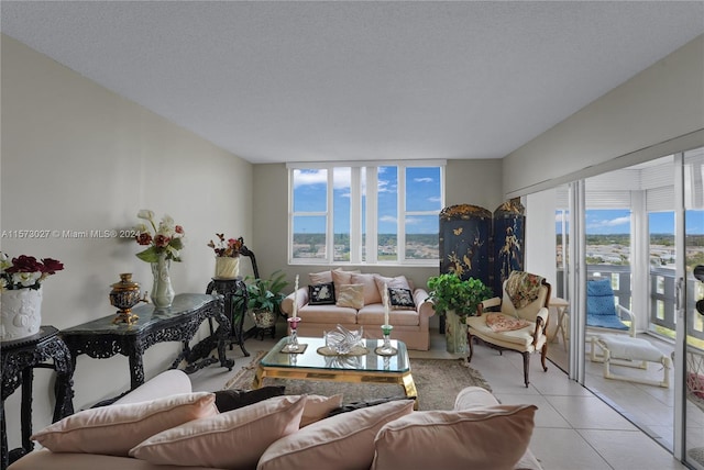 living room with a textured ceiling and light tile flooring