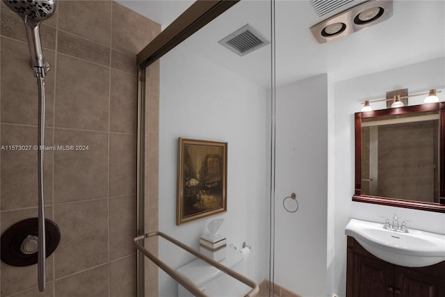 bathroom featuring large vanity and a shower with shower door