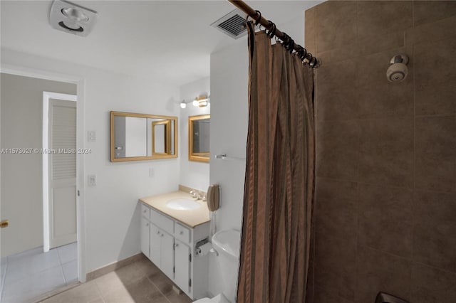 bathroom featuring tile flooring and vanity with extensive cabinet space