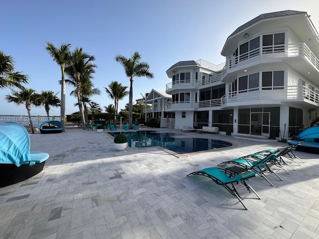 view of swimming pool featuring a patio area