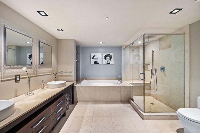 full bathroom with separate shower and tub, toilet, tile patterned flooring, and vanity