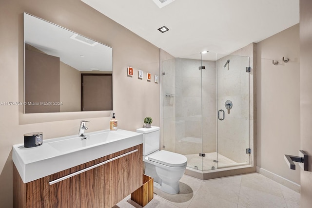 bathroom with tile patterned flooring, a shower with door, toilet, and vanity