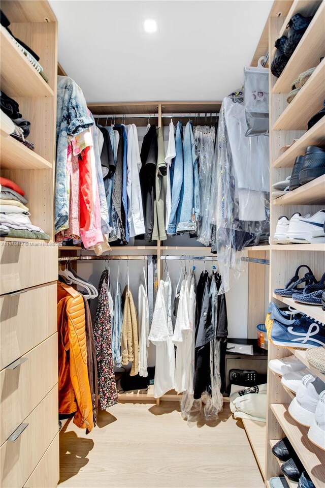 spacious closet with light hardwood / wood-style flooring