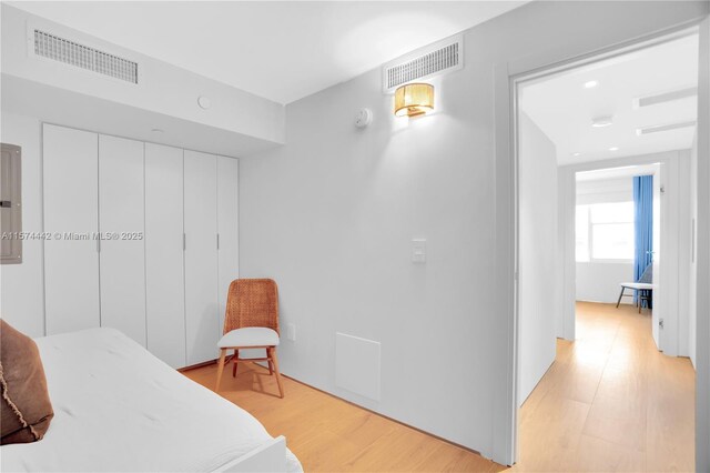 bedroom featuring light hardwood / wood-style flooring and a closet