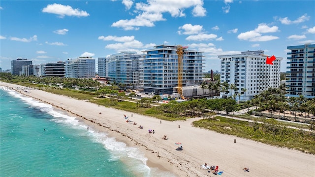 drone / aerial view featuring a beach view and a water view