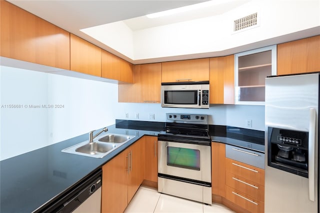 kitchen with stainless steel appliances, light tile floors, and sink