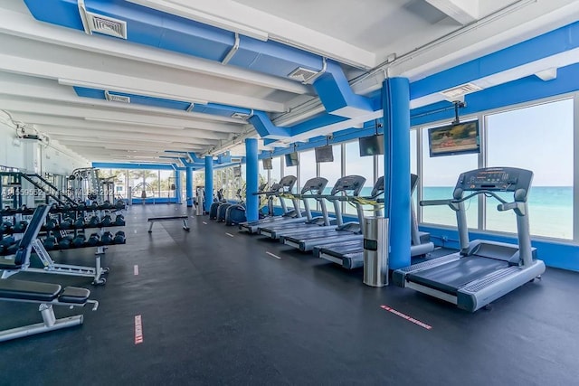 gym featuring a water view