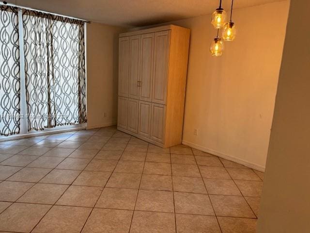 spare room featuring light tile floors