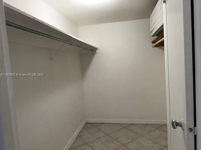 spacious closet featuring light tile floors