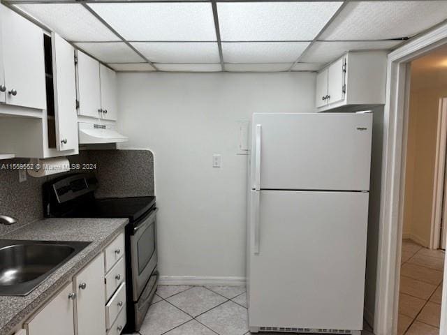 kitchen with white cabinets, white fridge, electric range, and a paneled ceiling