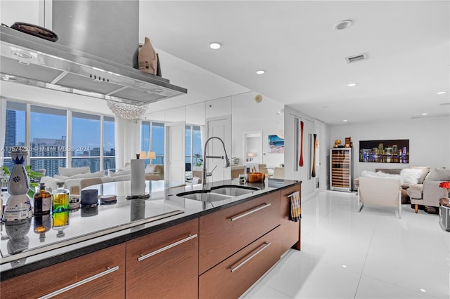 kitchen featuring exhaust hood, sink, and light tile floors