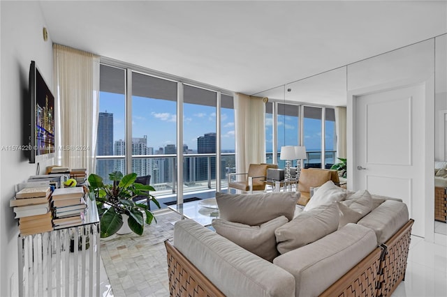 tiled living room featuring a wall of windows