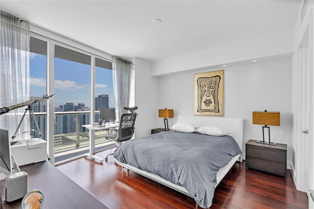 bedroom featuring dark wood-type flooring and access to exterior