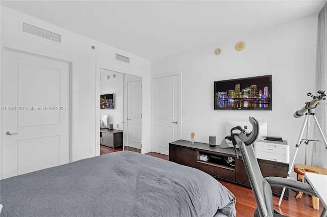 bedroom with dark hardwood / wood-style floors