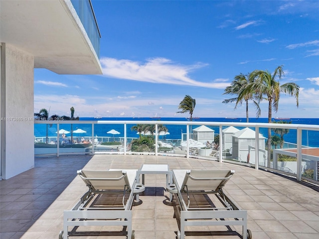 view of patio / terrace with a water view and a balcony