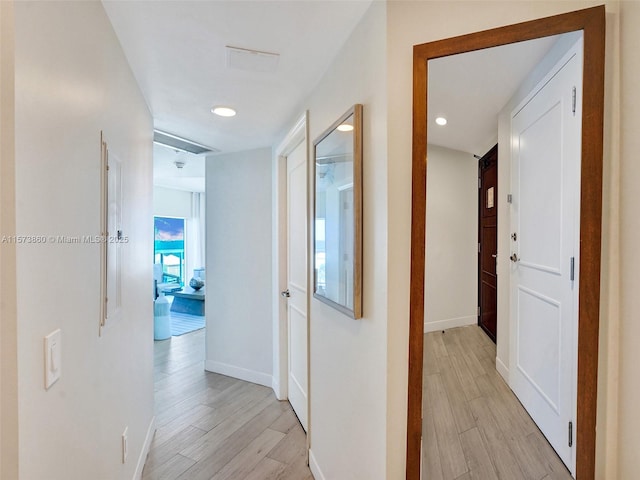 corridor with light hardwood / wood-style flooring